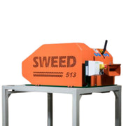 Close-up image of a Sweed CE513 strapping chopper machine resting on a grey metal frame on a white background