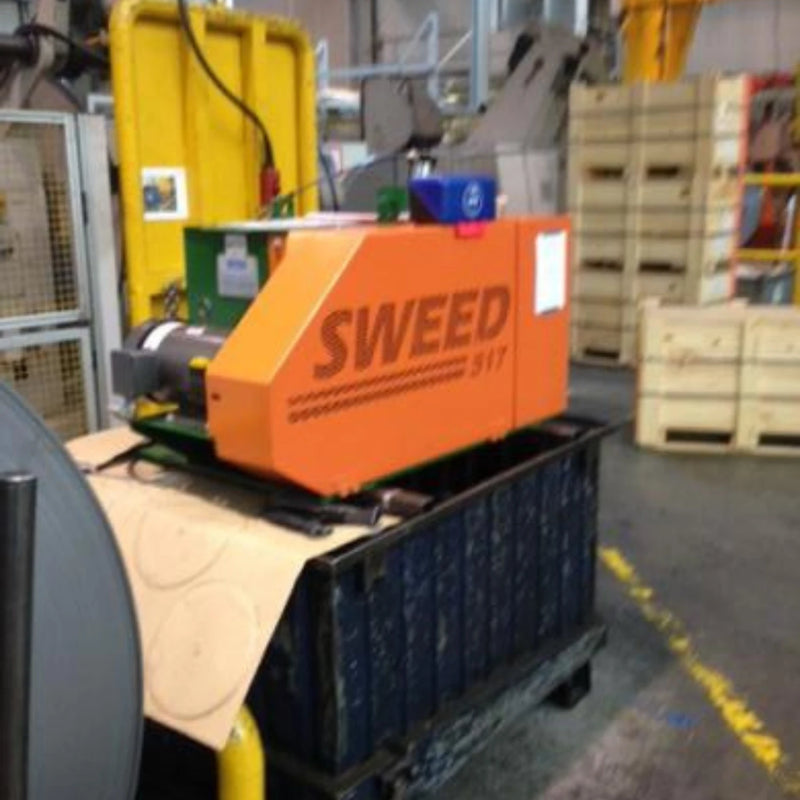 Image of a Sweed CE517XHD strapping chopper machine in a warehouse setting