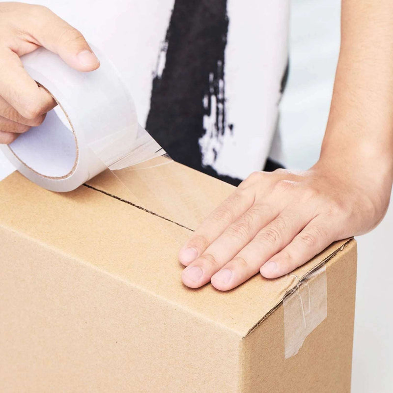 A man sealing a cardboard box with clear sealing tape