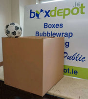 extra large double wall cardboard box beside a football in front of Box Depot advertising