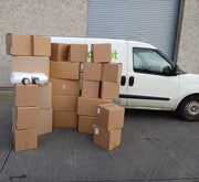 Bargain Moving Kit from Box Depot displaying all the boxes and accessories in the kit in front of the Box Depot van for perspective