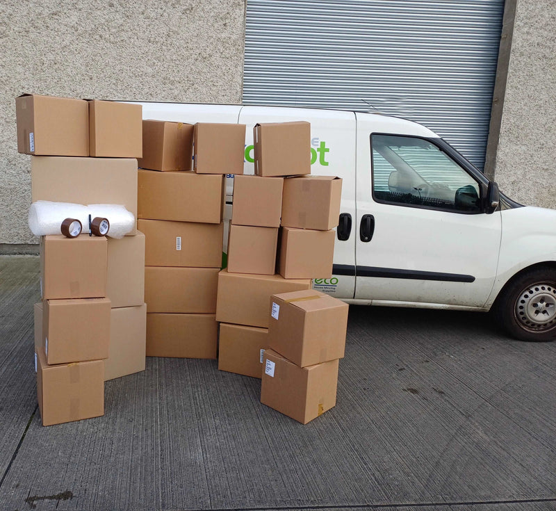 Bargain Moving Kit from Box Depot displaying all the boxes and accessories in the kit in front of the Box Depot van for perspective