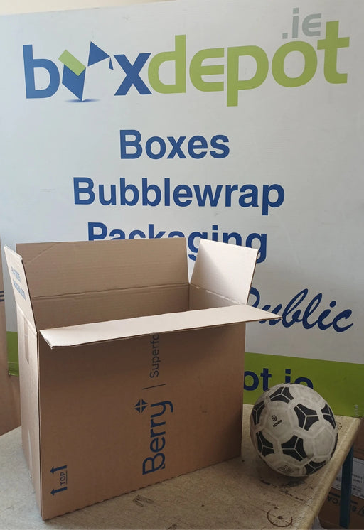 Medium single walled cardboard box next to a football for size perspective in front of Box Depot advertising