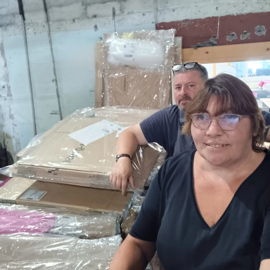 Maeve and Jerry of Box Depot in the Box Depot warehouse standing beside parcels ready to be shipped to customers