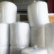 bales of bubble wrap rolls in a warehouse setting