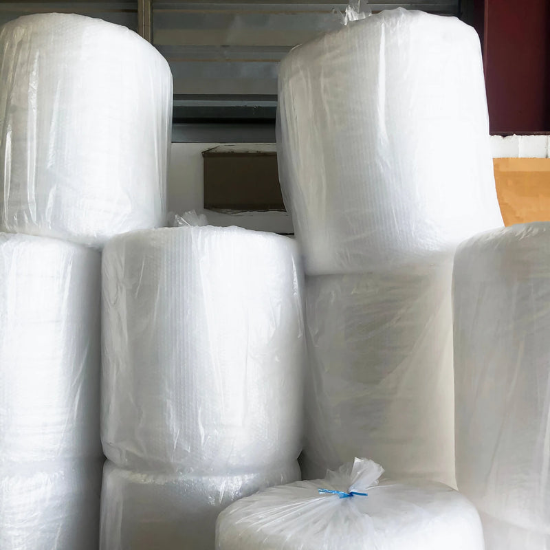 bales of bubble wrap rolls in a warehouse setting