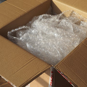 Open cardboard box filled with bubble wrap
