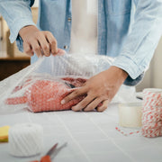 Man wrapping a parcel using bubble wrap