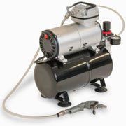 Small air compressor with hose and nozzle on a white background for use with Bubl air cushioning packaging