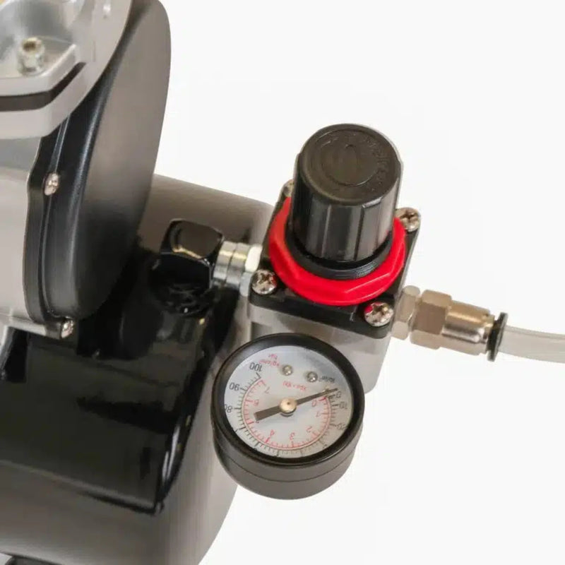 closeup of the air pressure gauge on an air compressor used to inflate Bubl air cushioning packaging on a white background