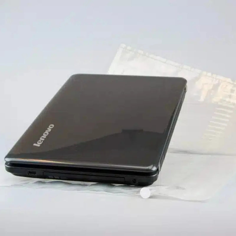 black laptop on an uninflated Bubl air cushioning pod on a plain background