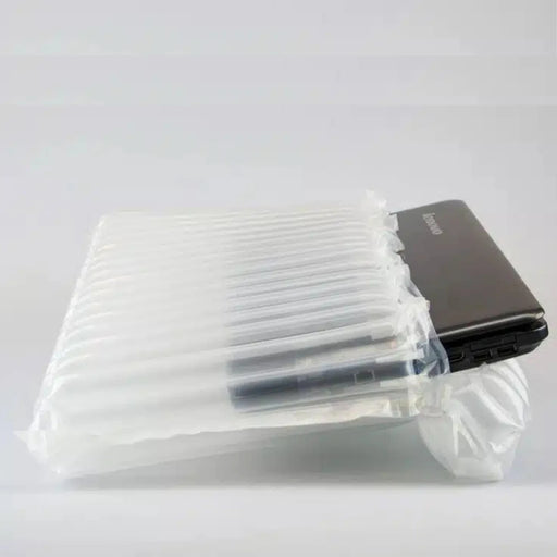 a 15" laptop protected by a Bubl air cushioning pod on a plain background