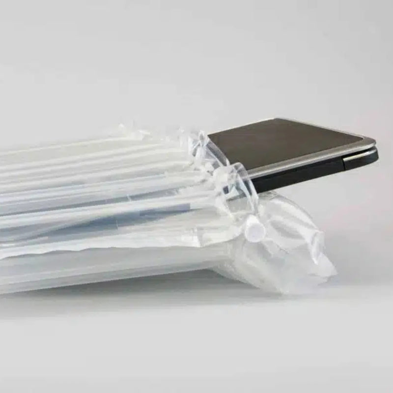 closeup of a laptop computer inside a Bubl air cushioning pod on a plain background 