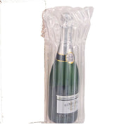 Bottle of champagne in a clear protective Bubl Air Cushioning pod ready for shipping on a white background