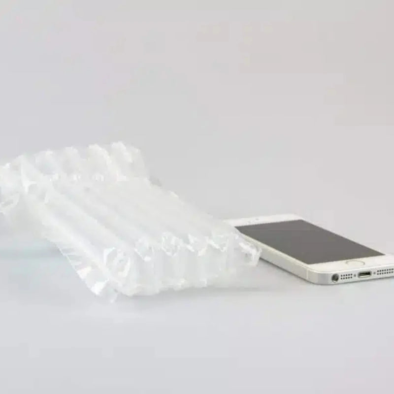 a smartphone beside an inflated protective Bubl air cushioning pod on a plain background