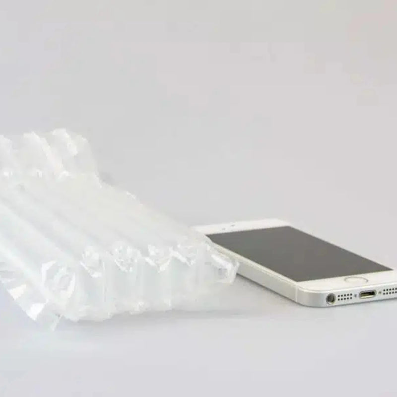 a mobile phone beside an inflated protective Bubl air cushioning pod on a plain background