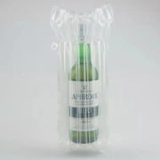 a bottle of whiskey inside an inflated Bubl Single air cushioning pod on a plain background