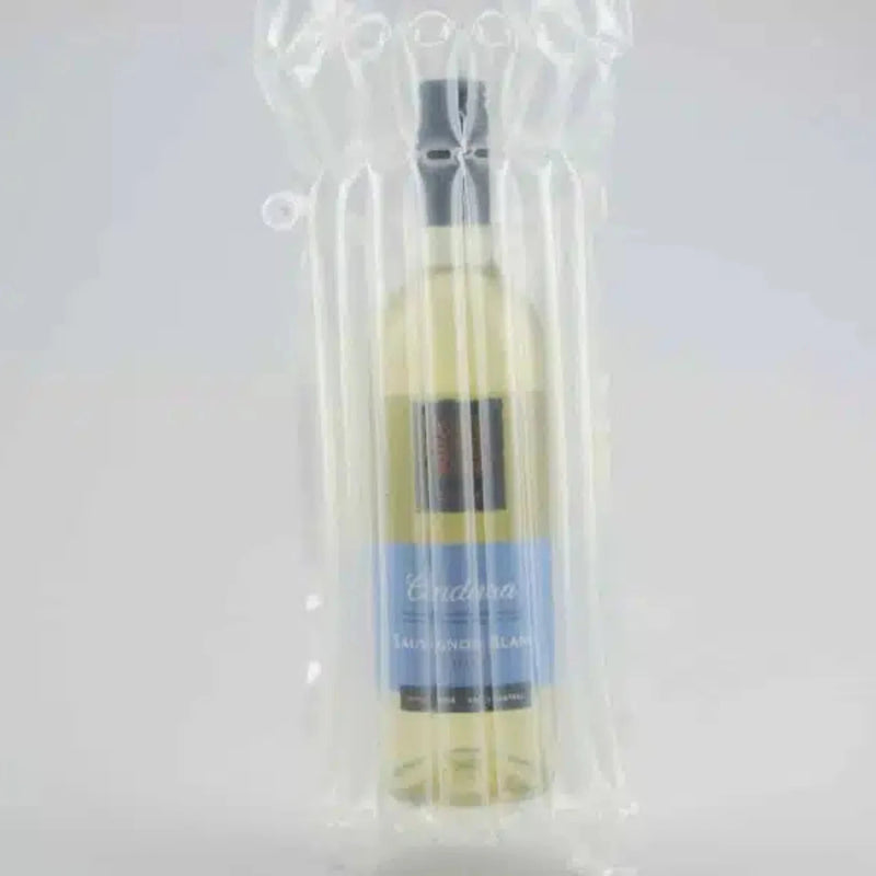 a bottle of white wine inside a protective Bubl Single air cushioning pod on a plain background