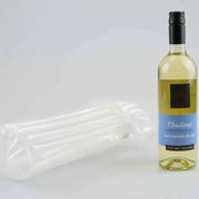 a bottle of white wine beside an inflated Bubl Single air cushioning pod on a plain background