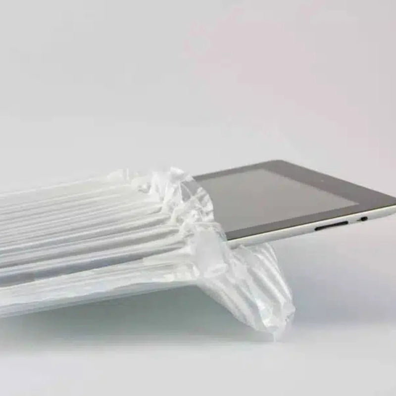 closeup of a computer tablet in an inflated protective bubl air cushioning pod on a plain background