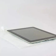 A computer tablet beside an uninflated bubl air cushioning pod on a plain background