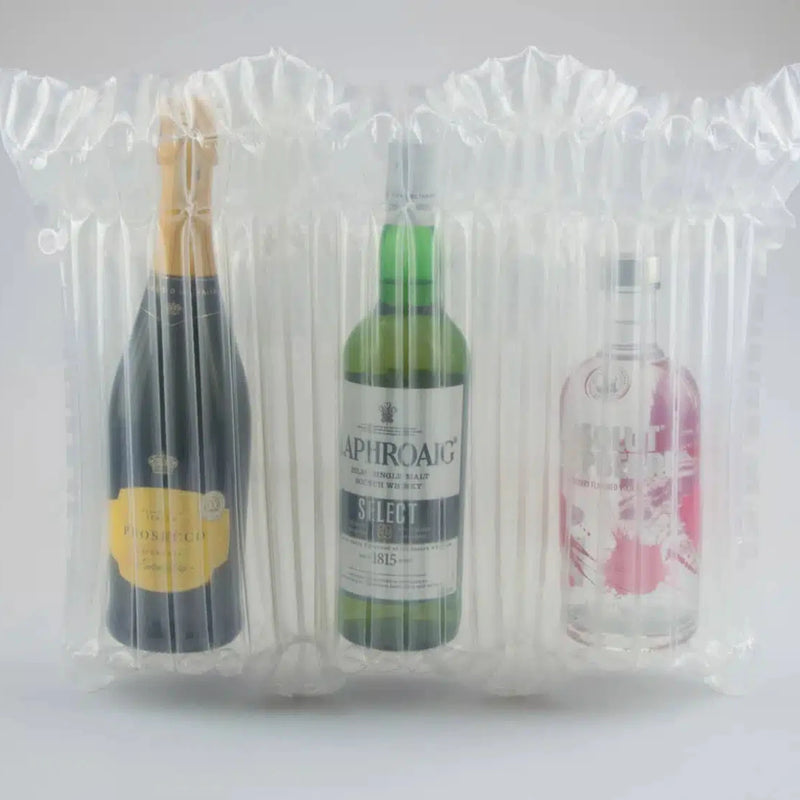 three bottles, each of prosecco, whiskey and vodka packaged inside a Bubl Triple air cushioning pod on a plain background