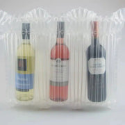 three bottles of wine packaging inside a Bubl Triple air cushioning pod on a plain background