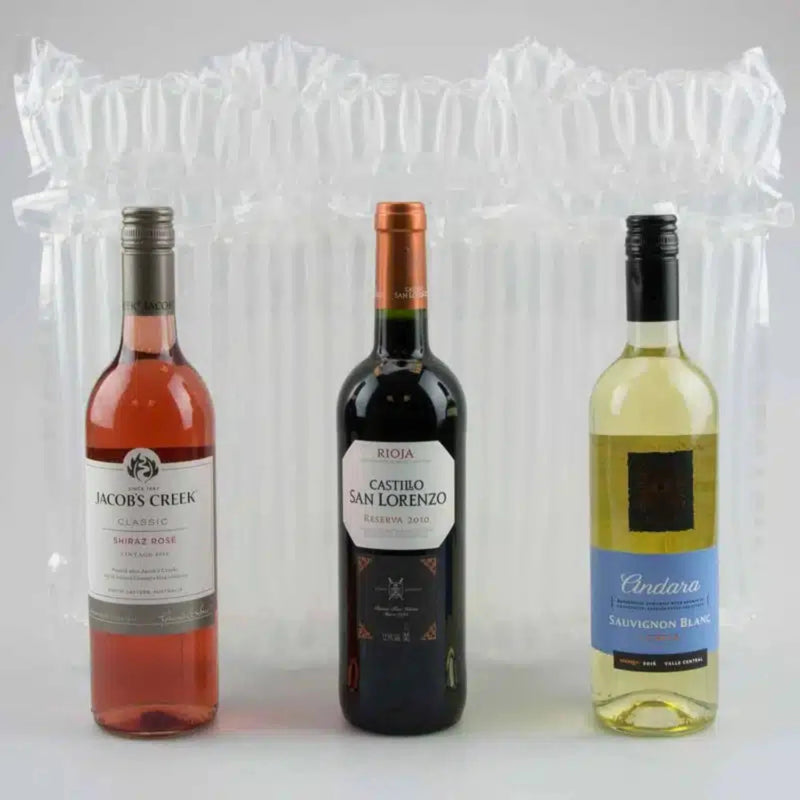 three bottles of wine in front of an inflated Bubl Triple air cushioning pod on a plain background