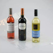 three bottles of wine beside an uninflated Bubl Triple air cushioning pod on a plain background
