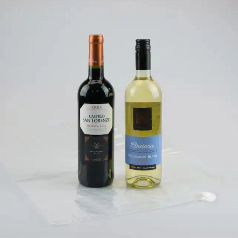 two bottles of wine beside an uninflated Bubl Double air cushioning pod on a plain background