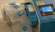 closeup of a Bubl inflation machine inflating Bubl Void air cushioning packaging on a plain background