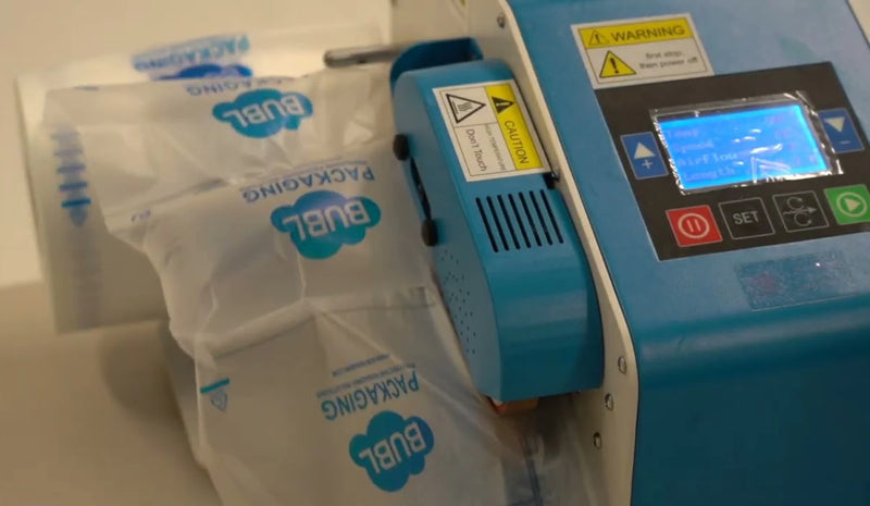 closeup of a Bubl inflation machine inflating Bubl Void air cushioning packaging on a plain background