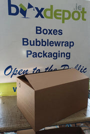 medium single walled cardboard box in front of Box Depot advertising