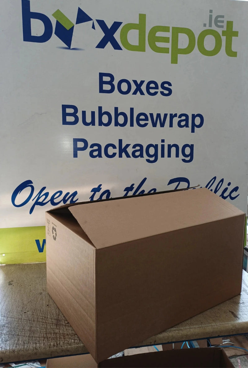 medium single walled cardboard box in front of Box Depot advertising