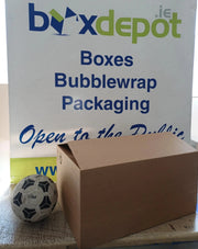 Medium single walled cardboard box beside a football for perspective in front of Box Depot advertising