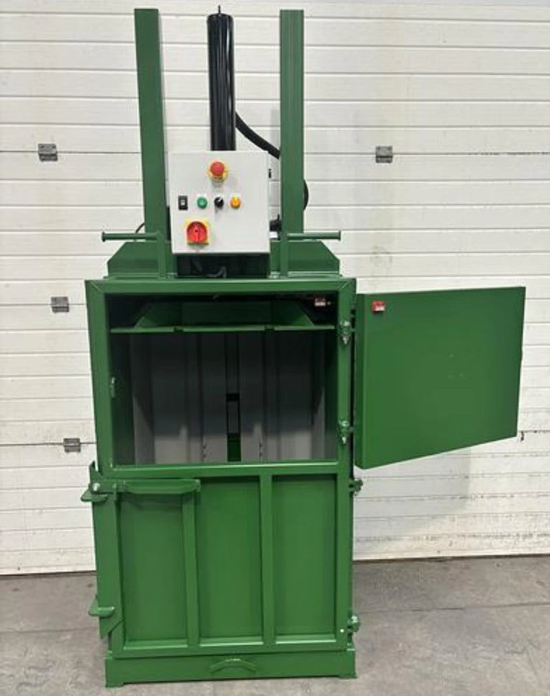 front view of a GE100 Cardboard baler with the upper door open in warehouse surroundings