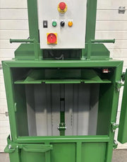 closeup of the front opening of a GE100 cardboard baler in warehouse surroundings