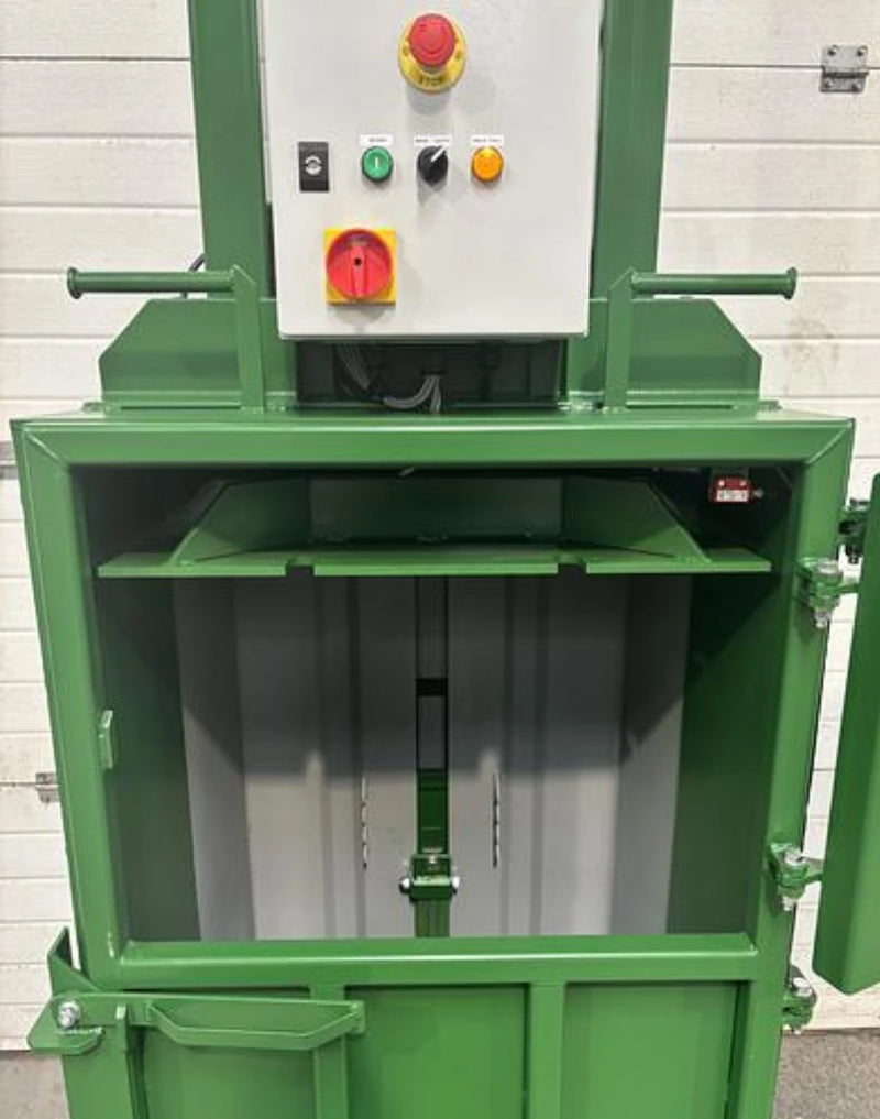 closeup of the front opening of a GE100 cardboard baler in warehouse surroundings