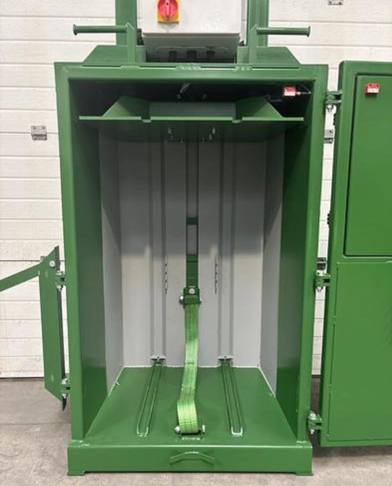 the inner section of a GE100 cardboard baler where cardboard is flattened to be baled in warehouse surroundings