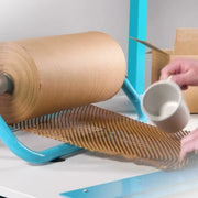 Grip paperflex honeycomb paper on a desktop stand being used to wrap a china mug