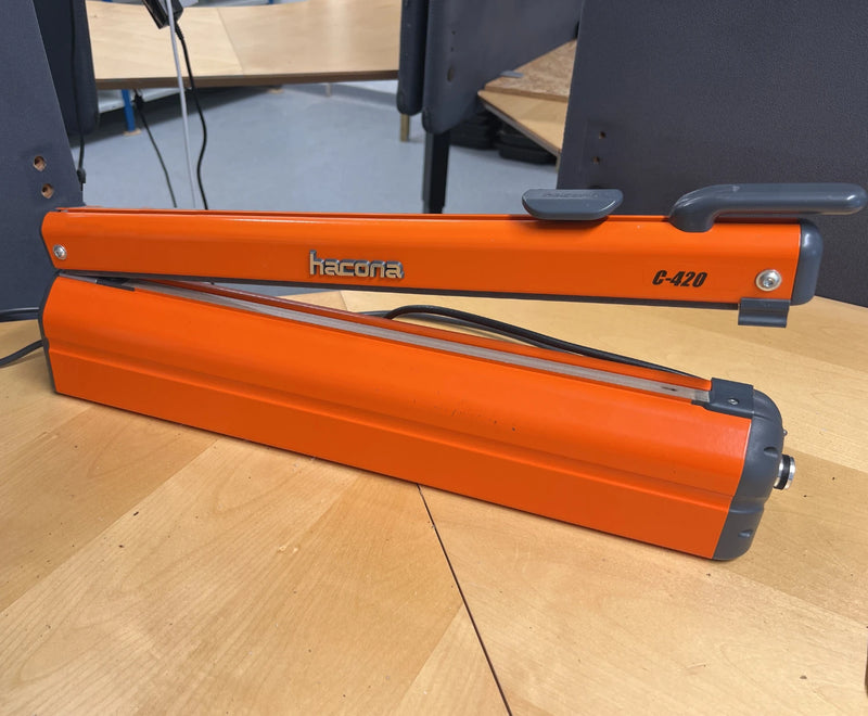 Hacona C420 Heat Sealer on a desk in an office environment