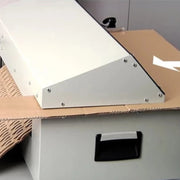 Close up image of cardboard being fed through a Kobra FlexPack Desktop Cardboard Shredder