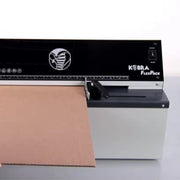 partial view of cardboard being fed into a Kobra FlexPack Cardboard Shredder