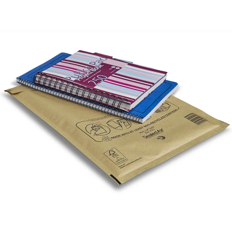 two A5 notebooks lying on top of a Seal Air Mail Lite padded envelope on a white background