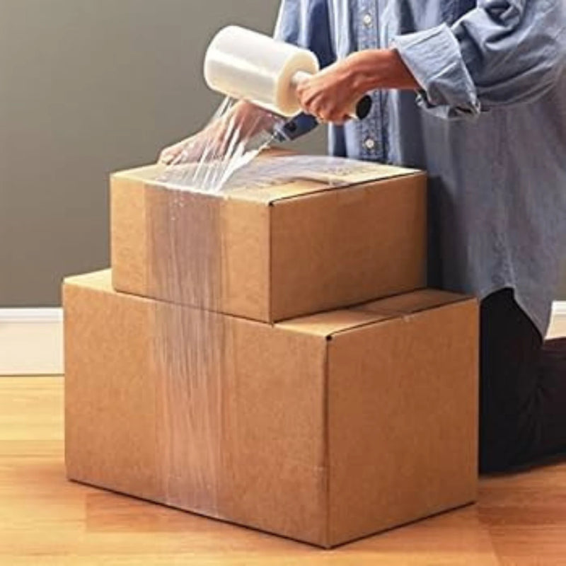 a person wrapping two cardboard boxes together using mini pallet wrap in a household setting