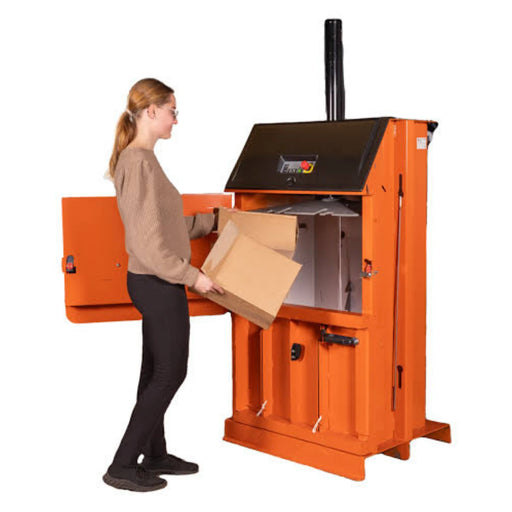 A woman placing cardboard boxes in an Orwak Compact 3110 Baler on a white background