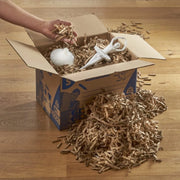 China ornaments inside a cardboard  box lined with shredded cardboard made with a CushionPack Cardboard Shredder