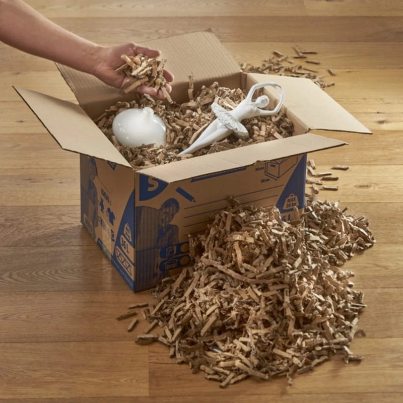 China ornaments inside a cardboard  box lined with shredded cardboard made with a CushionPack Cardboard Shredder