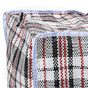 Closeup of the edging of a large plastic woven storage bag on a white background