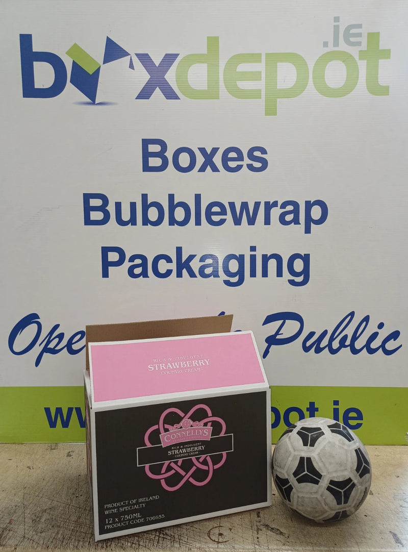 pink and black cardboard box beside a football in front of Box Depot advertising
